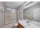 Bathroom featuring a tub-shower combo, sink, mirror and white cabinets at 2705 Brill St, Las Vegas, NV 89108