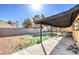 A covered patio area and a hot tub complete this backyard at 3337 Irv Marcus Dr, Las Vegas, NV 89108