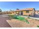 This backyard features a covered patio, a hot tub, and minimal landscaping at 3337 Irv Marcus Dr, Las Vegas, NV 89108