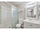 The white bathroom features a shower with a glass door and a white vanity with a sink at 3337 Irv Marcus Dr, Las Vegas, NV 89108