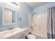 This bathroom has blue walls, a shower-tub combo and a white vanity at 3337 Irv Marcus Dr, Las Vegas, NV 89108