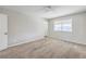 An empty bedroom featuring neutral carpet and white walls with a window featuring blinds at 3337 Irv Marcus Dr, Las Vegas, NV 89108