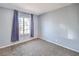 This carpeted bedroom features a window dressed with dark purple curtains at 3337 Irv Marcus Dr, Las Vegas, NV 89108