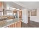Modern kitchen featuring granite countertops, wood cabinets, and stainless steel appliances at 3337 Irv Marcus Dr, Las Vegas, NV 89108