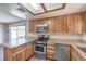 The kitchen is equipped with stainless steel appliances, granite countertops, and wood cabinets at 3337 Irv Marcus Dr, Las Vegas, NV 89108