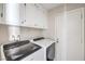This laundry room features a washer, dryer, and white cabinets for storage at 3337 Irv Marcus Dr, Las Vegas, NV 89108