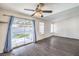 Inviting living room with wood flooring, ceiling fan, and sliding glass doors leading to the backyard at 3337 Irv Marcus Dr, Las Vegas, NV 89108