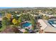 Expansive aerial view of a community featuring a pool, palm trees, and desert landscape at 378 Colleen Ct # G, Mesquite, NV 89027