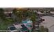 Aerial view of community pool and hot tub with palm trees and mountain views in the distance at 378 Colleen Ct # G, Mesquite, NV 89027