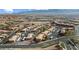 An aerial view of the apartment complex and desert landscaping showing parking and mountain range in background at 378 Colleen Ct # G, Mesquite, NV 89027