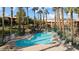 Community pool featuring desert landscaping and ample seating for residents to enjoy the outdoor amenities at 378 Colleen Ct # G, Mesquite, NV 89027