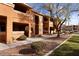 Exterior of apartment building with manicured landscaping and covered patios at 378 Colleen Ct # G, Mesquite, NV 89027