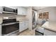Bright kitchen with stainless steel appliances, window view, and granite countertops and modern cabinets at 378 Colleen Ct # G, Mesquite, NV 89027