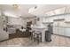 Open-concept layout with a modern kitchen, bar seating, and a cozy living room area at 378 Colleen Ct # G, Mesquite, NV 89027