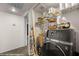 Laundry room with a large washing machine and storage shelves at 378 Colleen Ct # G, Mesquite, NV 89027