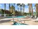 Community pool and hot tub with waterfall feature and lounge chairs at 378 Colleen Ct # G, Mesquite, NV 89027