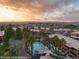 Community pool is surrounded by palm trees in this sunset shot of the complex at 378 Colleen Ct # G, Mesquite, NV 89027