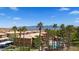 Well-maintained pool area with palm trees, seating, and clear blue skies at 378 Colleen Ct # G, Mesquite, NV 89027