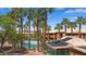 Palm trees surround the community pool with view of apartments in the background at 378 Colleen Ct # G, Mesquite, NV 89027