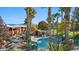 Community pool and deck area featuring palm trees, lounge chairs, and clubhouse at 378 Colleen Ct # G, Mesquite, NV 89027