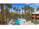 Great pool area with lounge chairs, landscaping, and mature trees at 378 Colleen Ct # G, Mesquite, NV 89027