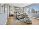 This modern bedroom features wood floors, neutral furniture, and large windows overlooking a water feature at 379 Portus Delphini Ct, Henderson, NV 89011