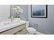 A stylish powder room with modern fixtures, a white sink, and a gray painted wall at 379 Portus Delphini Ct, Henderson, NV 89011