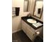 Bathroom features a sleek vanity with a black countertop and modern fixtures at 3850 Juno Beach St # 203, Las Vegas, NV 89129