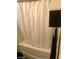 Bathroom features a bathtub with a white shower curtain at 3850 Juno Beach St # 203, Las Vegas, NV 89129