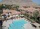 Aerial view of a sparkling pool with lounge chairs in a well-maintained community, with mountain views at 3850 Juno Beach St # 203, Las Vegas, NV 89129
