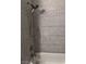Elegant bathroom showcasing sleek, textured gray tile and a modern showerhead at 3850 Juno Beach St # 203, Las Vegas, NV 89129