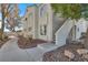 Condo exterior featuring stucco siding, staircase, and mature trees at 4404 W Lake Mead Blvd # 102, Las Vegas, NV 89108