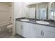 Bathroom featuring white cabinets, dual sinks, and bathtub at 4582 Mahogany Hills Ave, Las Vegas, NV 89141