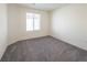 Neutral bedroom features gray carpet, and a bright window at 4582 Mahogany Hills Ave, Las Vegas, NV 89141