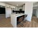 Modern kitchen with stainless steel appliances, a breakfast bar, and white cabinetry, perfect for culinary enthusiasts at 4954 Palmyra Ave, Las Vegas, NV 89146