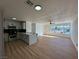 Inviting living space with modern kitchen, breakfast bar, and large windows that fill the area with natural light at 4954 Palmyra Ave, Las Vegas, NV 89146