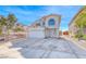 Exterior elevation of a two-story home with a large front yard and attached garage at 5301 Padua Way, Las Vegas, NV 89107