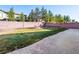 Large grassy backyard with mature trees and landscaping features, offering plenty of space to enjoy at 6360 Bullring Ln, Las Vegas, NV 89130
