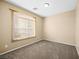 Bedroom with carpet flooring and a window providing natural light at 6360 Bullring Ln, Las Vegas, NV 89130