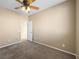 A cozy bedroom with neutral walls, carpeted floors, and a ceiling fan for added comfort at 6360 Bullring Ln, Las Vegas, NV 89130