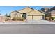 Inviting single-story home showcasing a three car garage and desert landscaping at 6360 Bullring Ln, Las Vegas, NV 89130