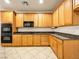 Well-equipped kitchen featuring wooden cabinets, granite countertops, and modern appliances for convenient cooking at 6360 Bullring Ln, Las Vegas, NV 89130