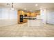 Bright kitchen featuring oak cabinetry, center island, and generous tile flooring at 6360 Bullring Ln, Las Vegas, NV 89130