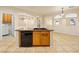 Kitchen island with a sink, dishwasher, and wooden cabinets offering practical functionality at 6360 Bullring Ln, Las Vegas, NV 89130