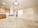 Bright kitchen featuring oak cabinetry, center island, and generous tile flooring at 6360 Bullring Ln, Las Vegas, NV 89130