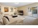 Comfortable living room showcasing neutral tones, stylish furnishings, and sliding glass doors at 6360 Bullring Ln, Las Vegas, NV 89130