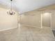 Expansive living area with neutral flooring and a chandelier, perfect for entertaining at 6360 Bullring Ln, Las Vegas, NV 89130