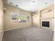 Spacious living room with a tile fireplace and large windows overlooking the backyard at 6360 Bullring Ln, Las Vegas, NV 89130