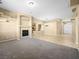 Carpeted living room featuring a fireplace, large archways, and open floor plan at 6360 Bullring Ln, Las Vegas, NV 89130