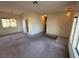 Spacious living room with carpeted floors, large window, and classic lighting fixture creating a warm ambiance at 6388 Canyon Dawn Ave, Las Vegas, NV 89108